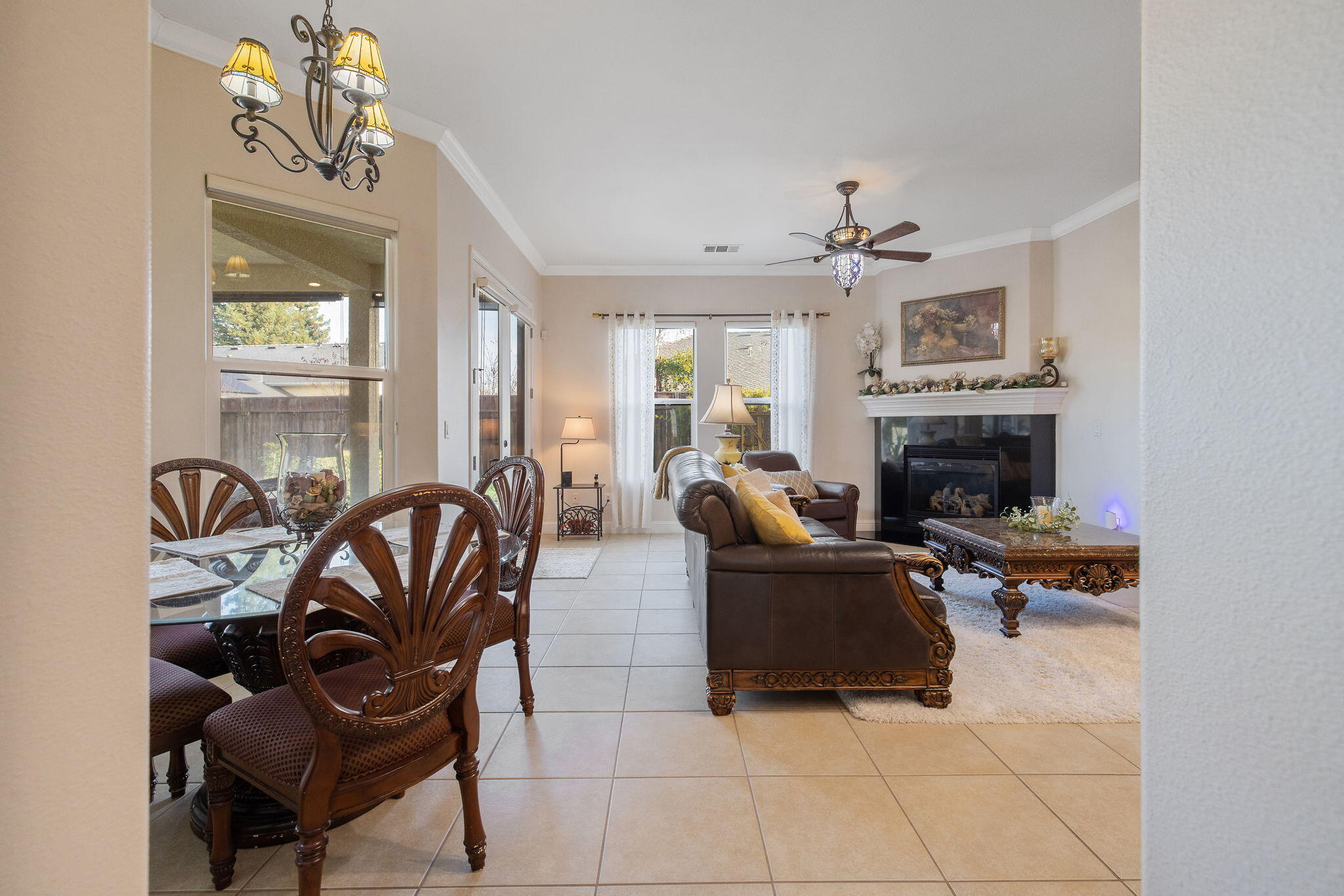 729 St Thomas Court Exeter, CA 93221 - Photo 13 of 66 a living room with furniture a fireplace and a chandelier