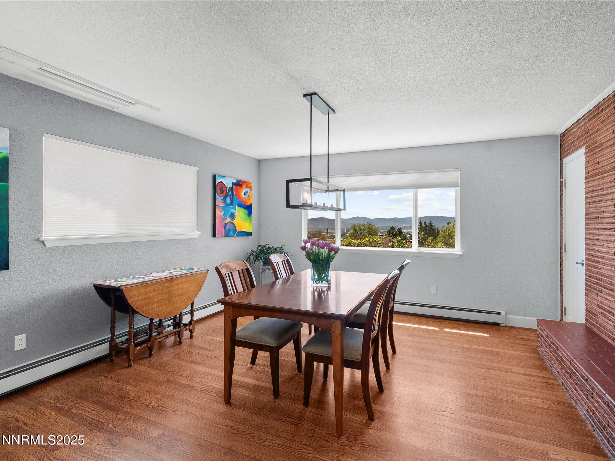 60 Redstone Drive Reno, NV 89512 - Photo 15 of 61 a dining room with furniture a rug a potted plant and wooden floor