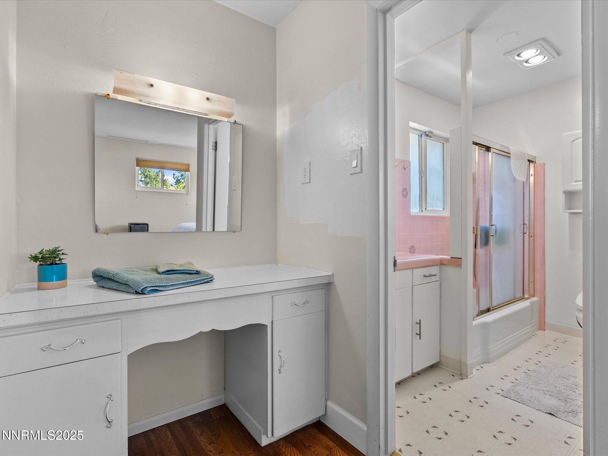 60 Redstone Drive Reno, NV 89512 - Photo 28 of 61 a en suite bathroom with a sink a mirror and a shower