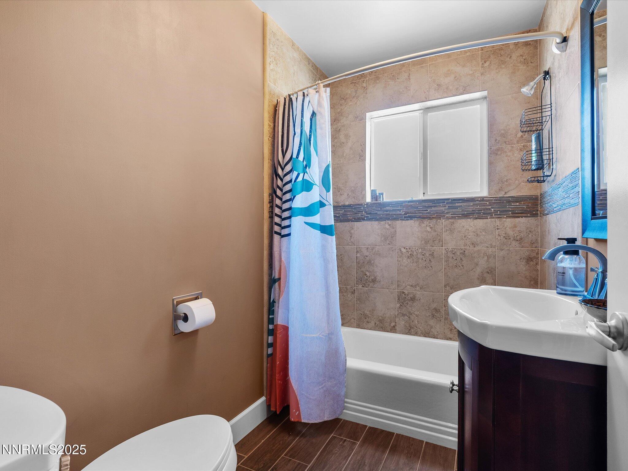 60 Redstone Drive Reno, NV 89512 - Photo 32 of 61 a bathroom with a sink a toilet and bathtub