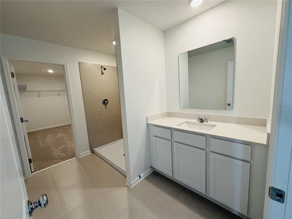 1386 Inkberry Circle DeLand, FL 32720 - Photo 12 of 16 a bathroom with a double vanity sink and mirror