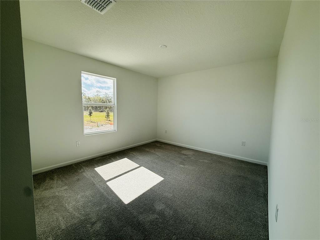 1386 Inkberry Circle DeLand, FL 32720 - Photo 7 of 16 an empty room with windows