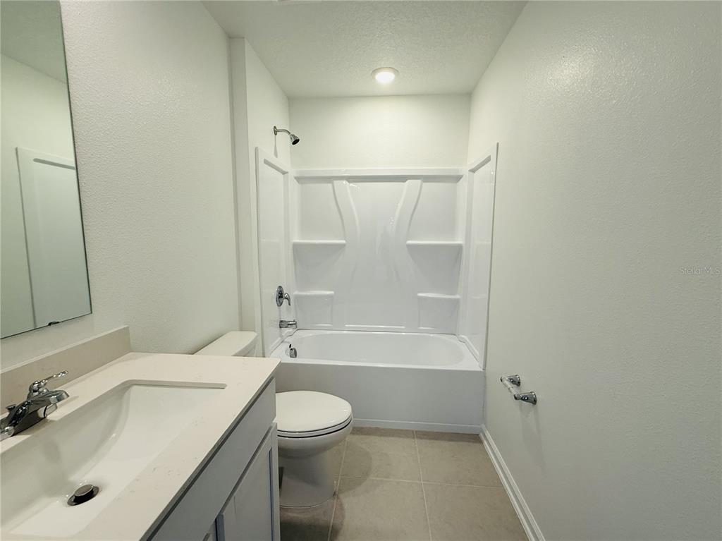 1386 Inkberry Circle DeLand, FL 32720 - Photo 8 of 16 a bathroom with a bathtub shower sink vanity and toilet