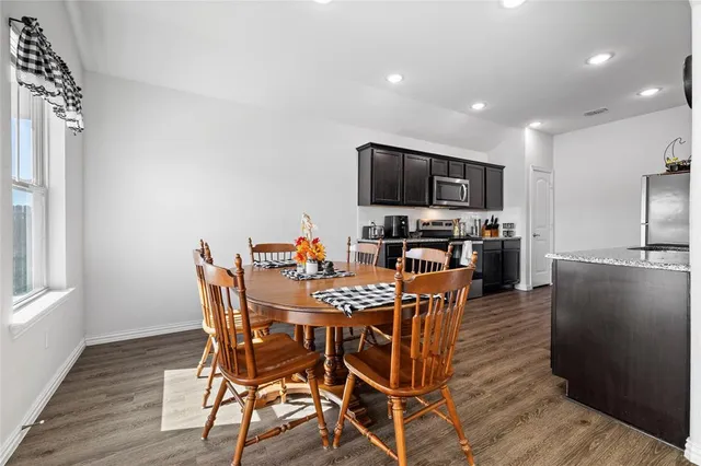 a view of a dining room with furniture and a wooden floor