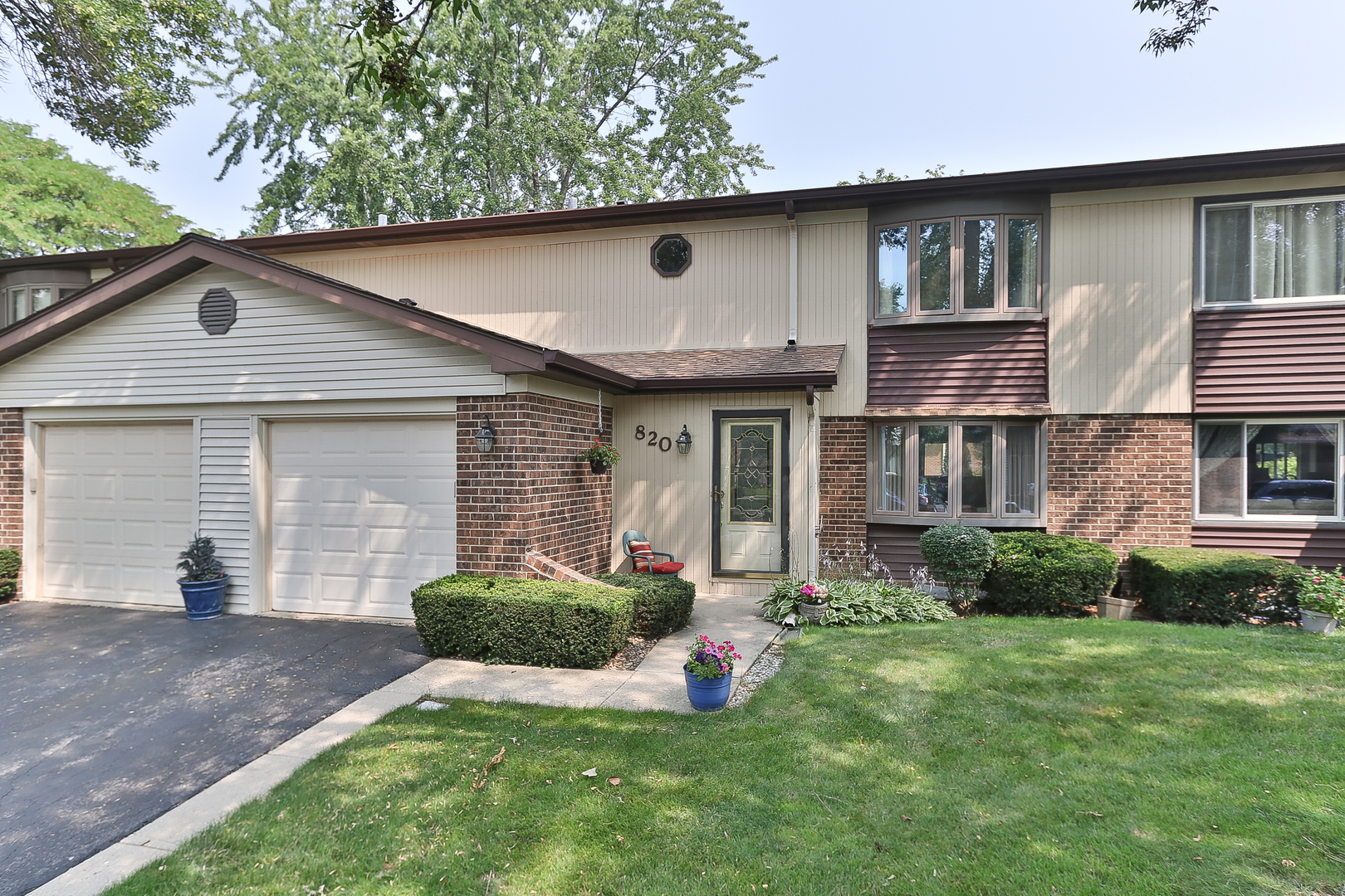820 West Partridge Lane, Unit 57 Mount Prospect, IL 60056 - Photo 1 of 1 a front view of a house with a yard and garage