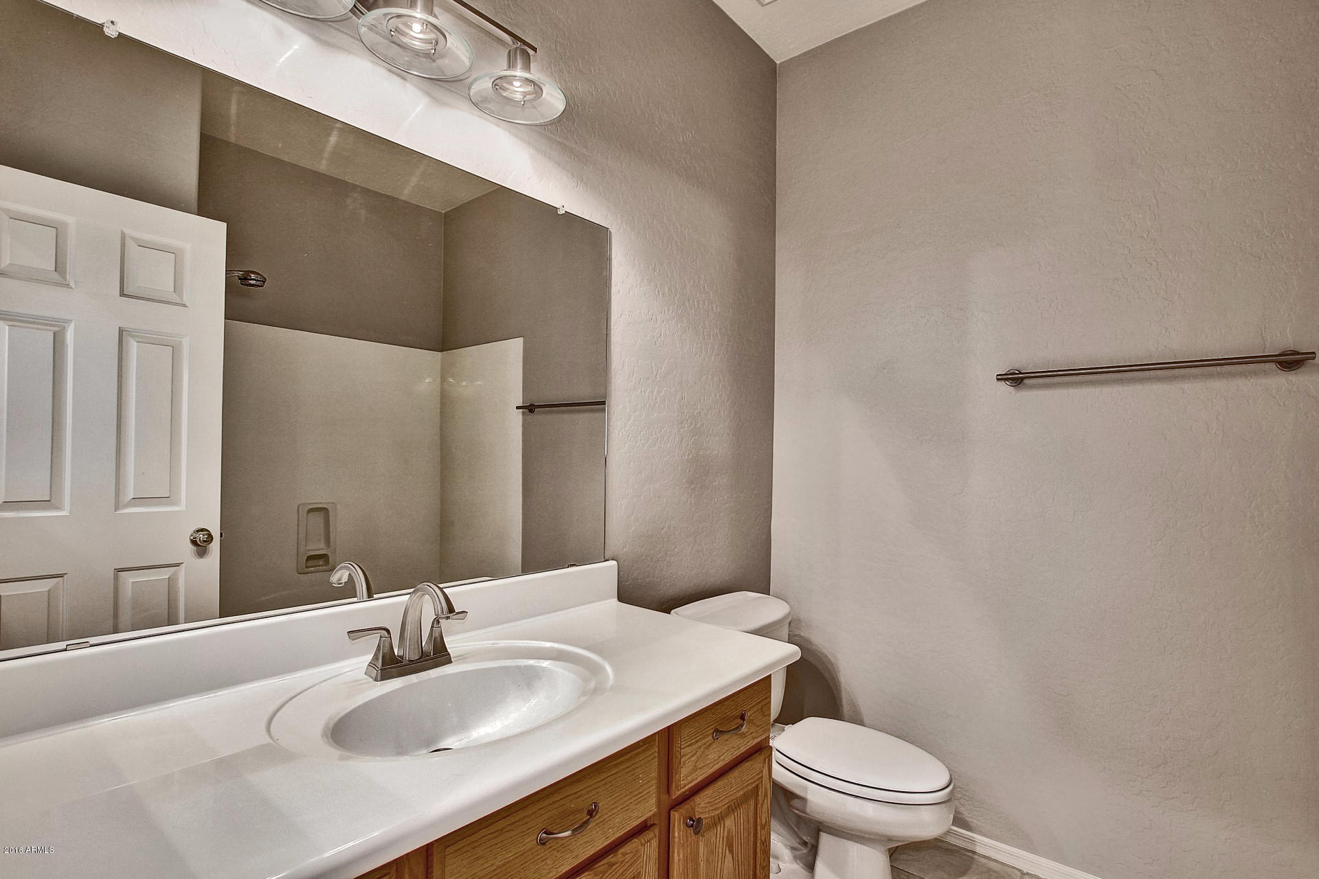 1360 East Harrison Street Gilbert, AZ 85295 - Photo 13 of 34 a bathroom with a granite countertop sink toilet a mirror and shower