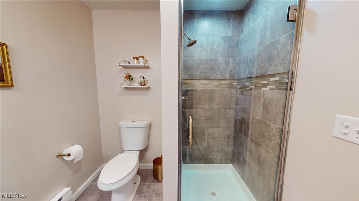 2412 Charney Road Cleveland, OH 44118 - Photo 23 of 48 Bathroom with a shower with door, toilet, and a baseboard heating unit