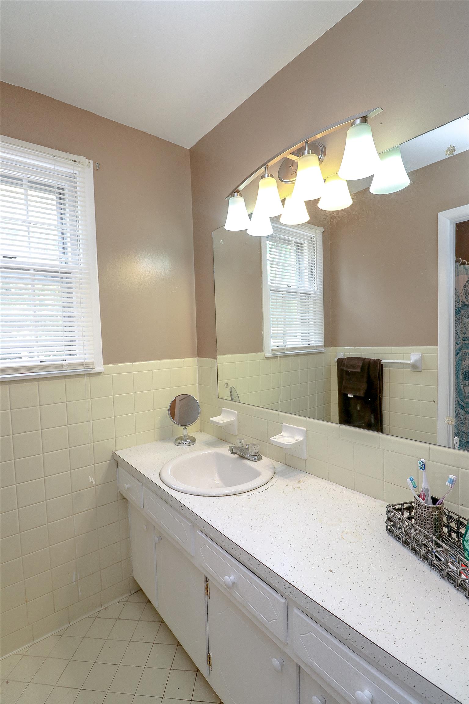 3016 Anderson Road Nashville, TN 37217 - Photo 15 of 25 a bathroom with a sink a vanity and a mirror