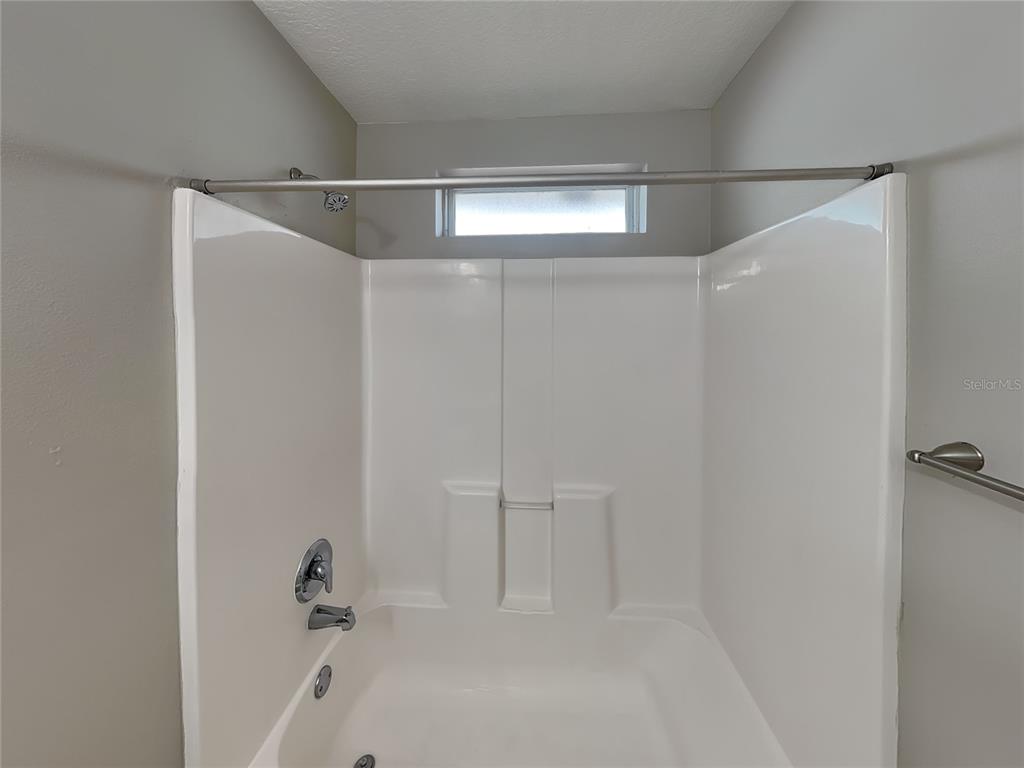 Undisclosed Address Port Orange, FL 32127 - Photo 15 of 16 a bathroom with a shower and a bath tub