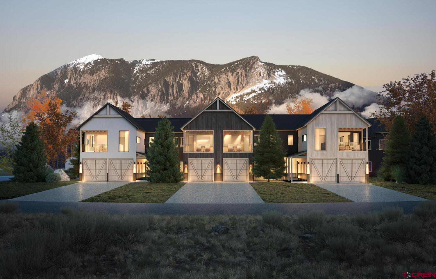 243 Elk Valley Road, Unit 1B Crested Butte, CO 81224 - Photo 5 of 9 a front view of a house with a yard and garage