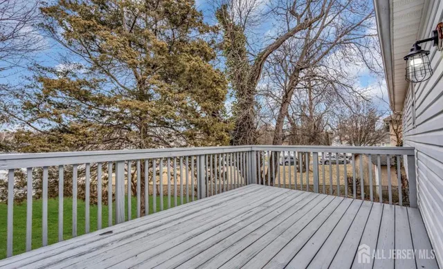 a balcony with wooden floor and fence