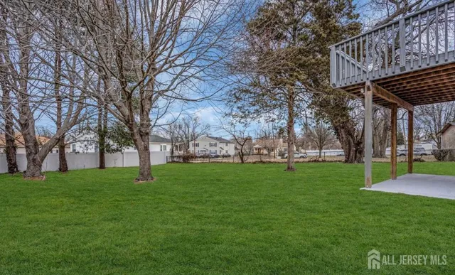 a view of a backyard with large trees