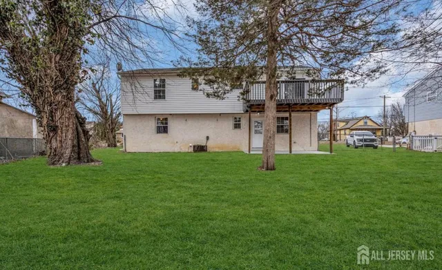 a view of a house with a backyard