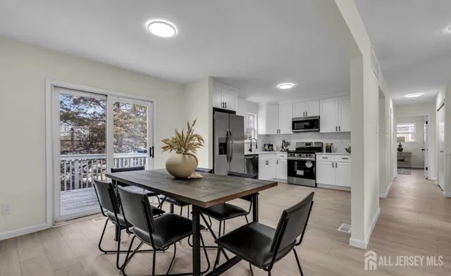 a dining room with furniture and wooden floor