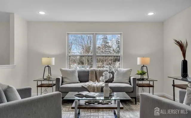 a living room with furniture and a large window