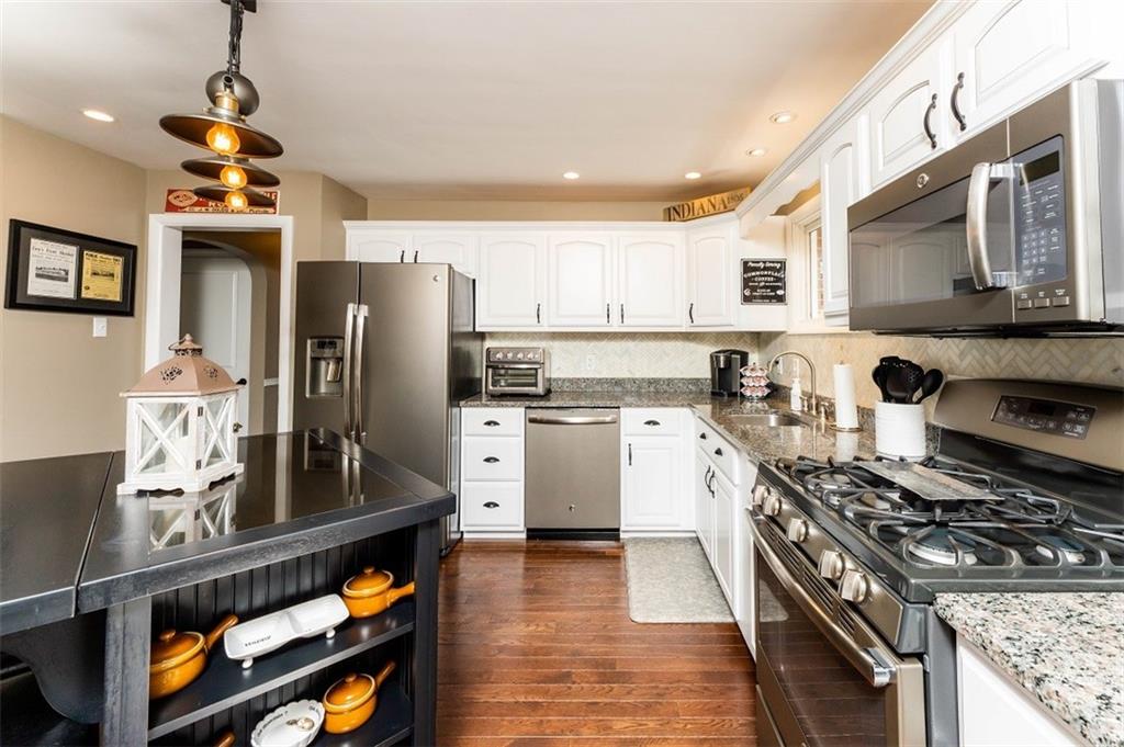 793 Rustic Lodge Road Indiana, PA 15701 - Photo 3 of 22 a kitchen with stainless steel appliances granite countertop a stove refrigerator sink and microwave