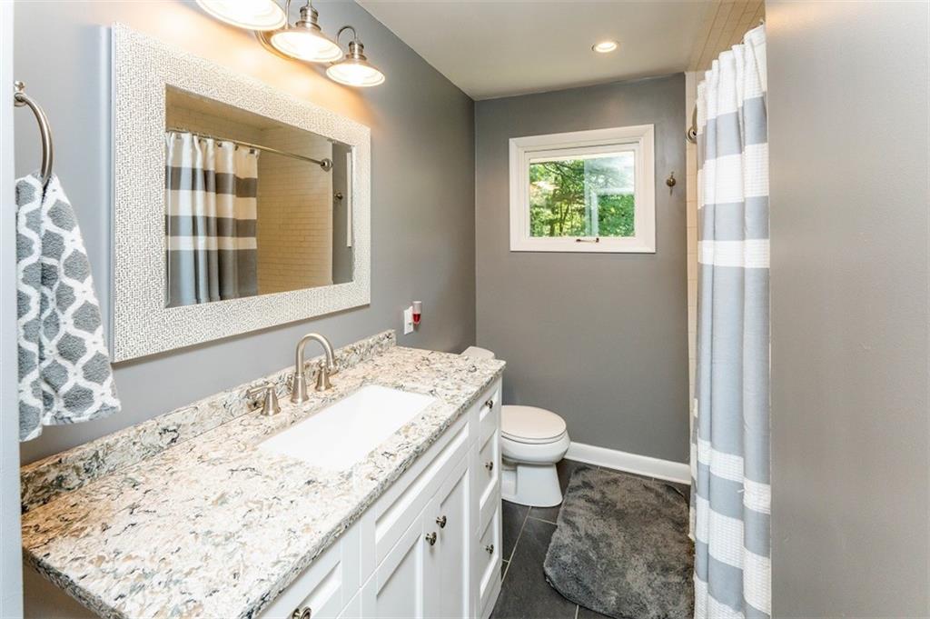 793 Rustic Lodge Road Indiana, PA 15701 - Photo 10 of 22 a bathroom with a granite countertop sink a toilet and a window