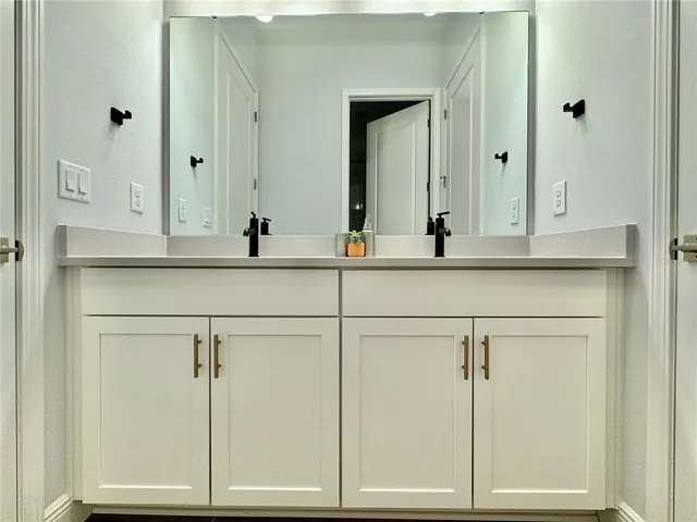 a kitchen with stainless steel appliances kitchen island granite countertop a dining table chairs and sink