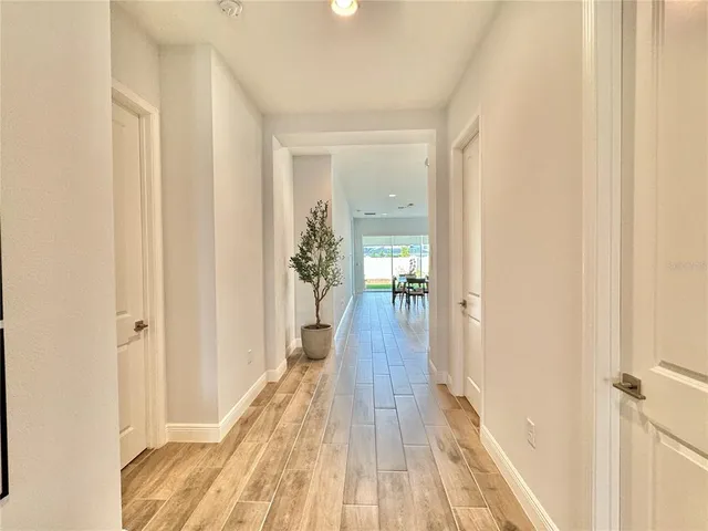 a kitchen with a dining table chairs sink and stove