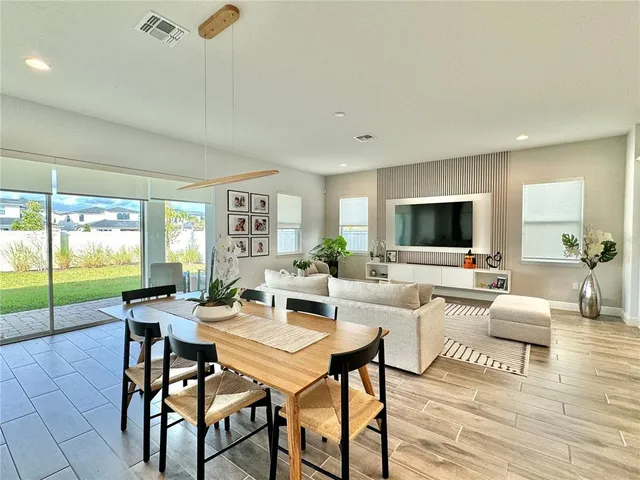 a kitchen with stainless steel appliances a refrigerator a sink a stove a microwave and wooden floor