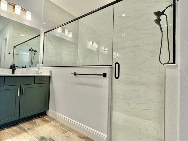 a living room with furniture kitchen view and a flat screen tv