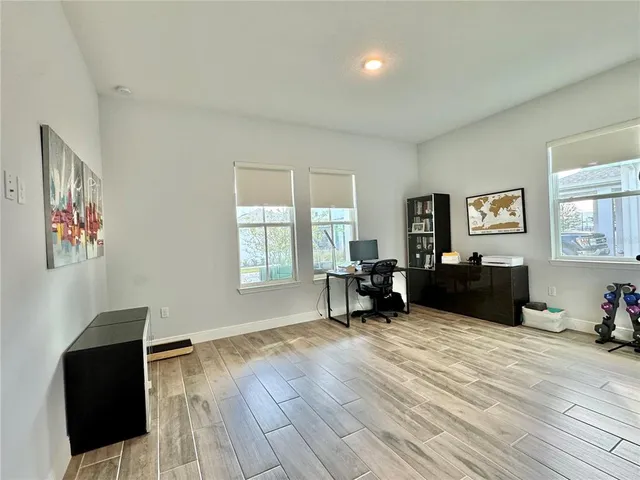 a view of a hallway with wooden floor and entryway