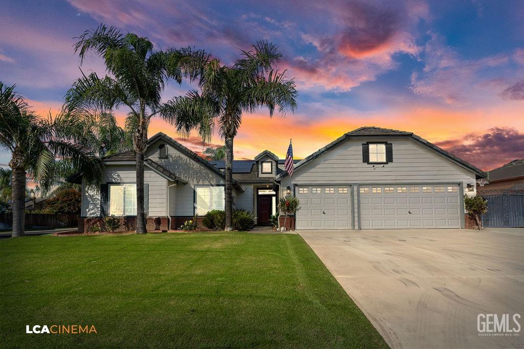 a view of house with a big yard and palm trees