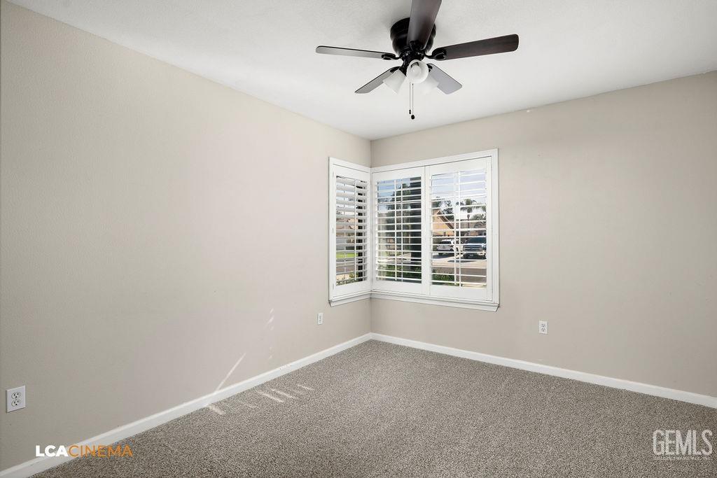 Undisclosed Address Bakersfield, CA 93312 - Photo 12 of 28 an empty room with a window and a ceiling fan