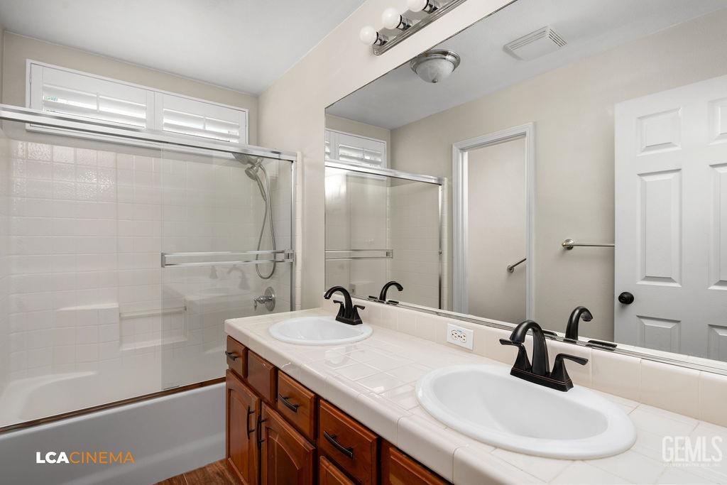 Undisclosed Address Bakersfield, CA 93312 - Photo 13 of 28 a bathroom with a sink and a mirror