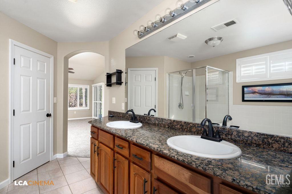 Undisclosed Address Bakersfield, CA 93312 - Photo 16 of 28 a bathroom with a double vanity sink and a mirror