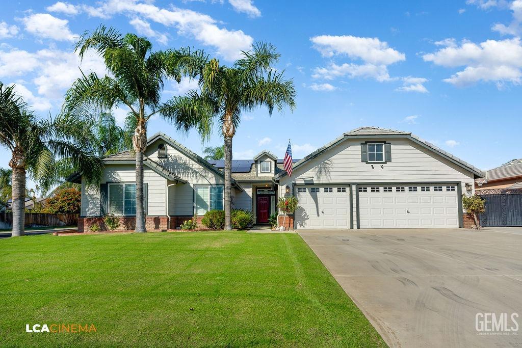 Undisclosed Address Bakersfield, CA 93312 - Photo 2 of 28 a view of white house with a big yard and palm trees