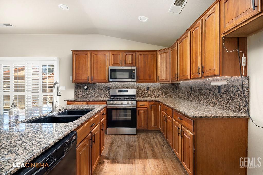 Undisclosed Address Bakersfield, CA 93312 - Photo 22 of 28 a kitchen with granite countertop a sink a counter top space cabinets and stainless steel appliances