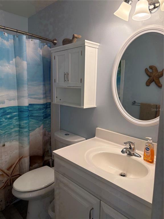 14531 Walsingham Road, Unit 225 Largo, FL 33774 - Photo 12 of 17 a bathroom with a sink and a mirror
