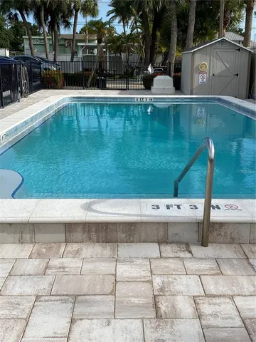 a view of a swimming pool with a yard