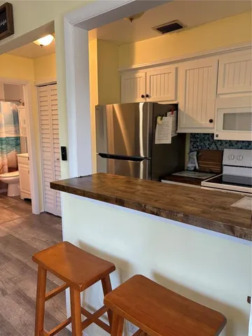a kitchen with a table chairs and a refrigerator