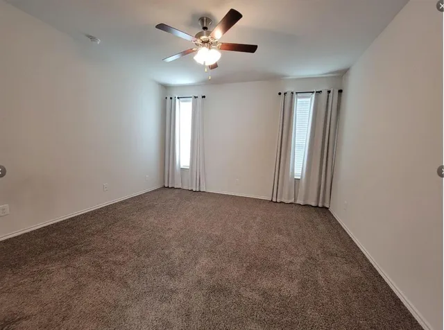 a view of a room with a ceiling fan and a chandelier fan