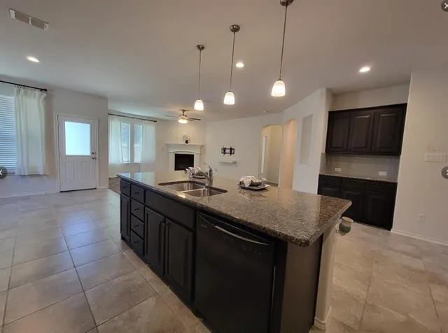 a bathroom with a sink a vanity and a large mirror
