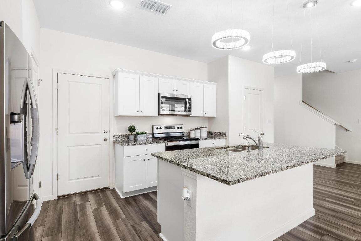 101 Magnum Force Drive Jarrell, TX 76537 - Photo 13 of 29 a kitchen with a sink stove and refrigerator