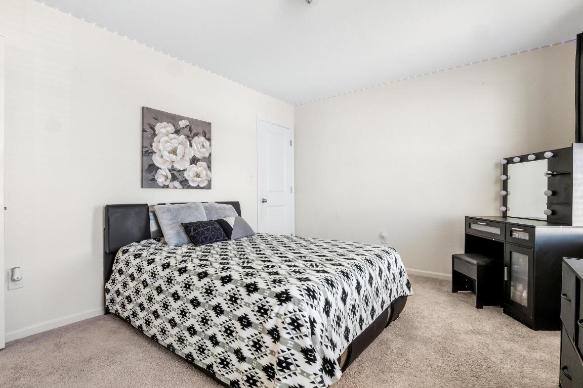 101 Magnum Force Drive Jarrell, TX 76537 - Photo 26 of 29 a bedroom with a bed and painting on the wall