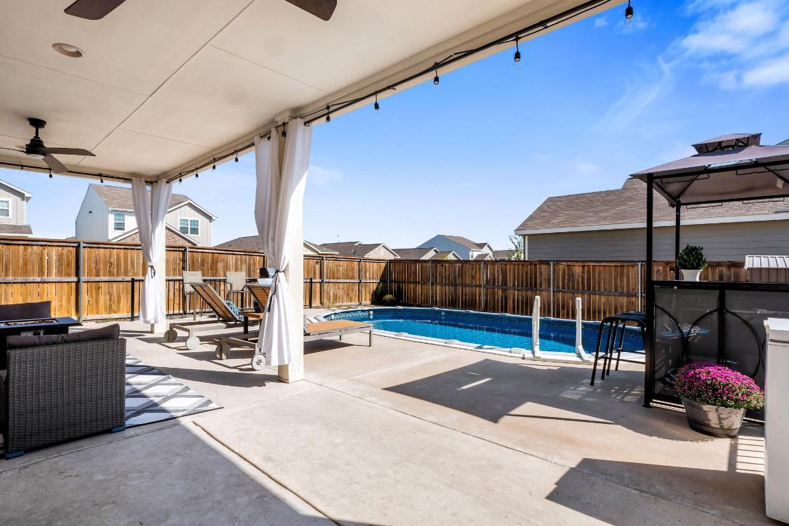 101 Magnum Force Drive Jarrell, TX 76537 - Photo 7 of 29 a view of a patio with table and chairs under an umbrella