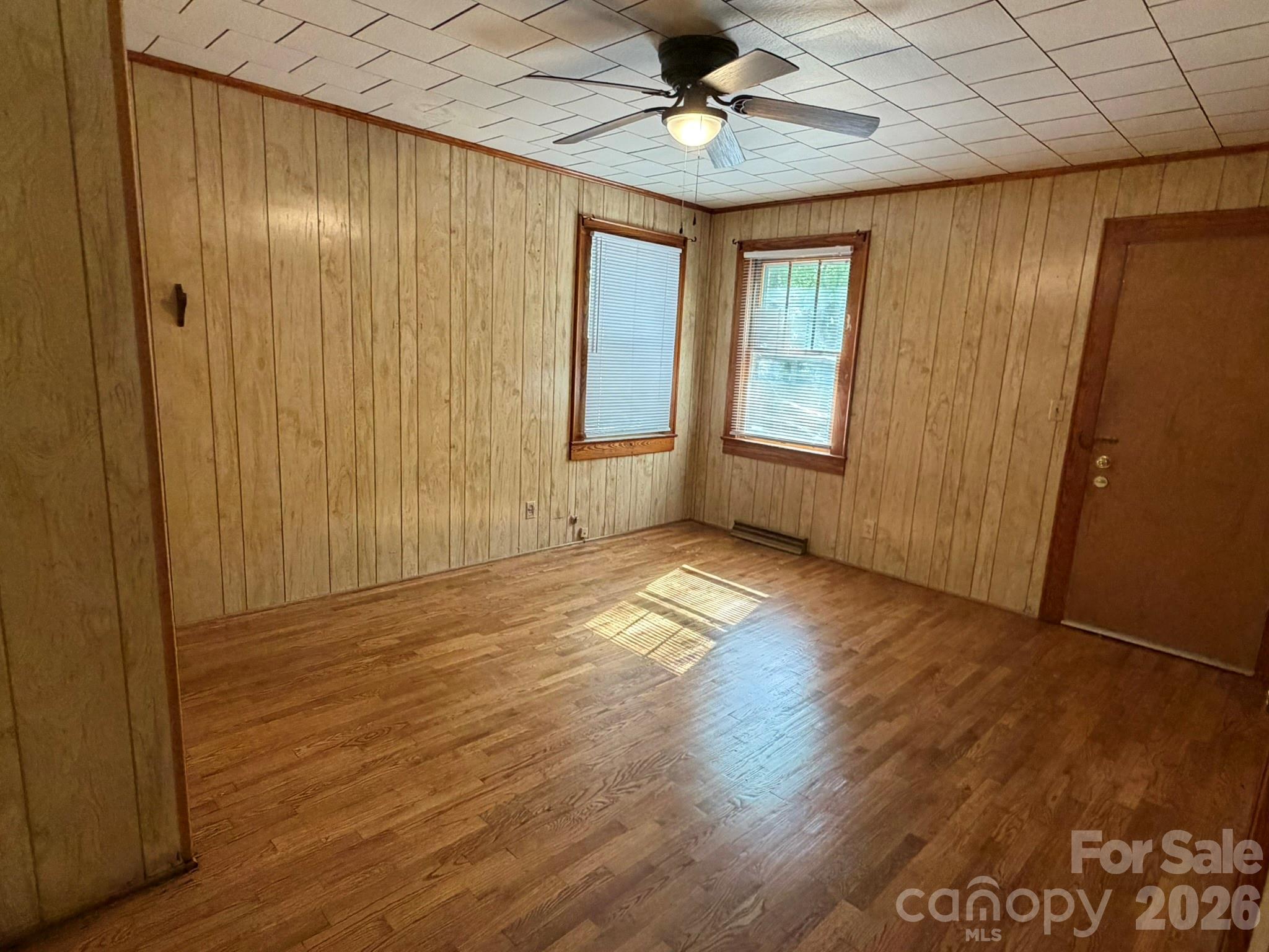 382 Alexis High Shoals Road Dallas, NC 28034 - Photo 22 of 43 a view of empty room with wooden floor and fan