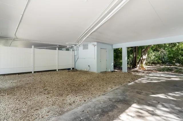 a view of a livingroom with a floor to ceiling window and tree