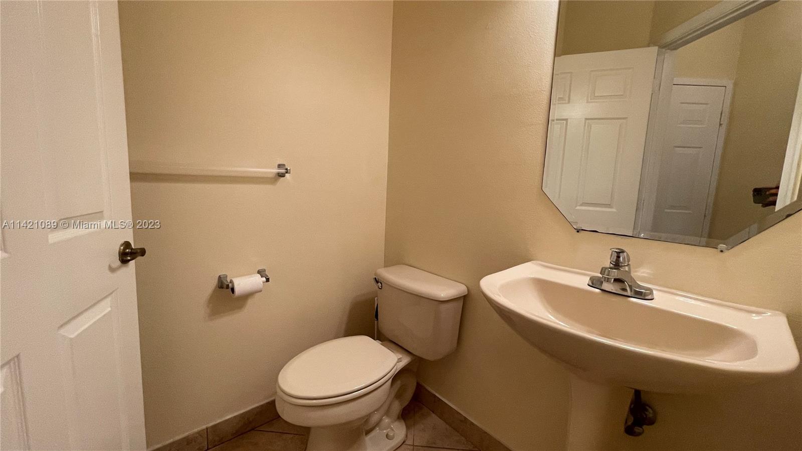 3123 Laurel Ridge Circle, Unit 3123 Riviera Beach, FL 33404 - Photo 8 of 18 a bathroom with a sink toilet and a mirror