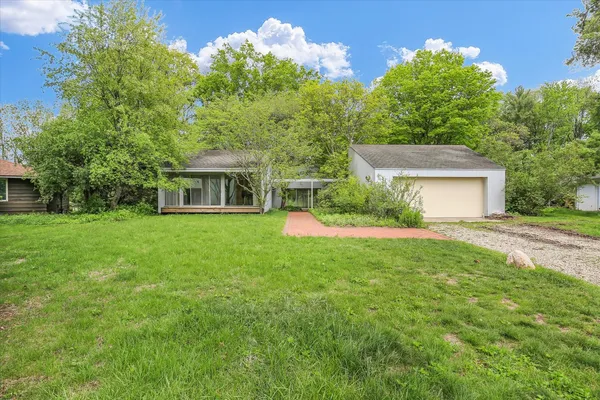 a front view of house with yard and green space