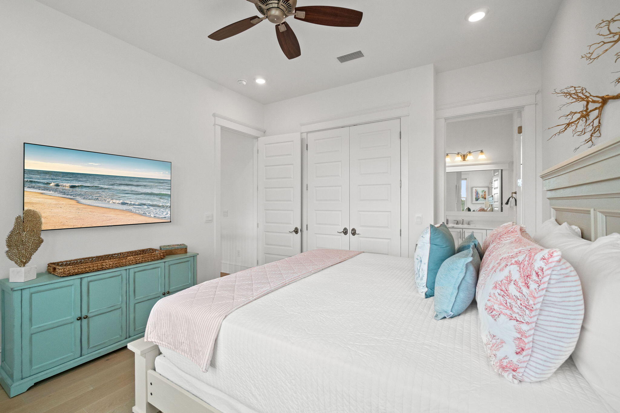 80 Seaboard Lane Santa Rosa Beach, FL 32459 - Photo 45 of 88 a bedroom with a bed and a chandelier