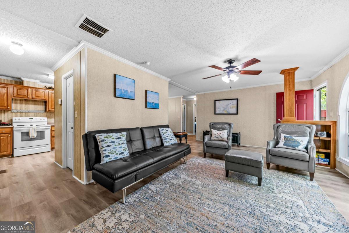 194 Phillips Road Eatonton, GA 31024 - Photo 18 of 57 a living room with furniture and a ceiling fan