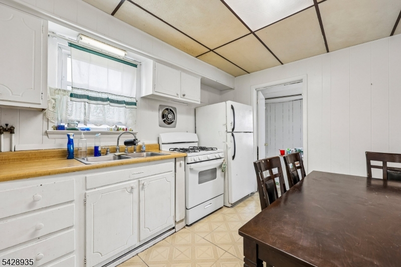 50 Preston Street Ridgefield Park, NJ 07660 - Photo 18 of 41 a kitchen with stainless steel appliances granite countertop a sink a stove a refrigerator a microwave oven with cabinets and wooden floor