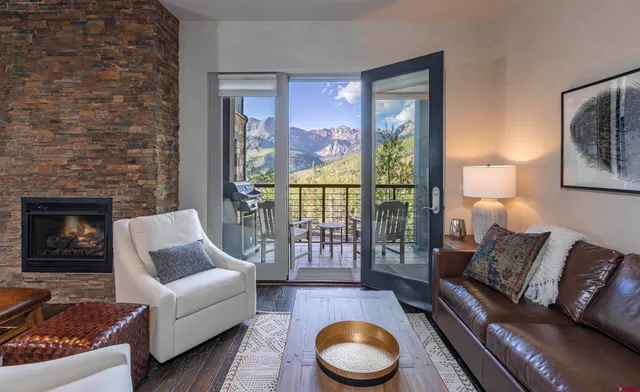 a living room with furniture and a fireplace