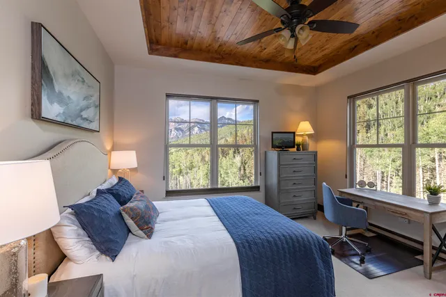 a bed room with a bed window and a desk