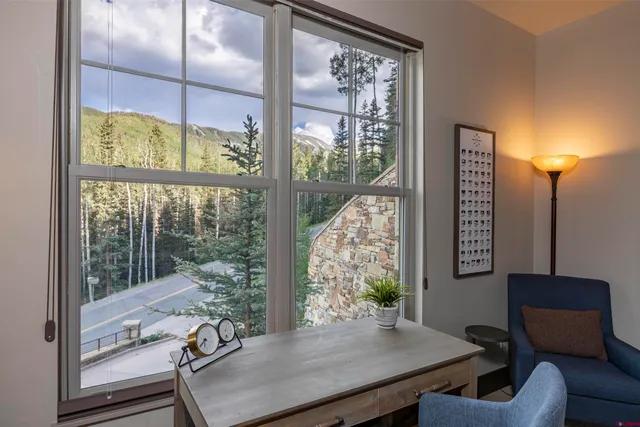 a view of a room with furniture and a window